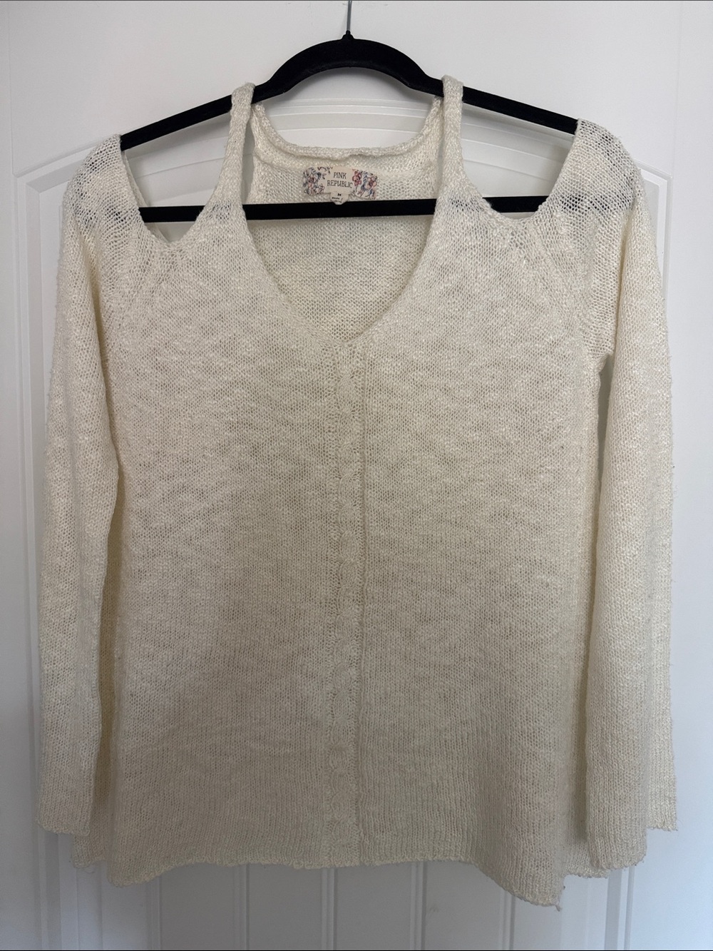 Pink Republic sweater features a cold-shoulder design with a v-neck